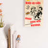 “Funny wall plaque reading 'Slapstick Wake Up Calls Should Come with Warnings' displayed on a kitchen wall near a coffee mug”