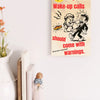 “Funny wall plaque reading 'Slapstick Wake Up Calls Should Come with Warnings' displayed on a kitchen wall near a coffee mug”