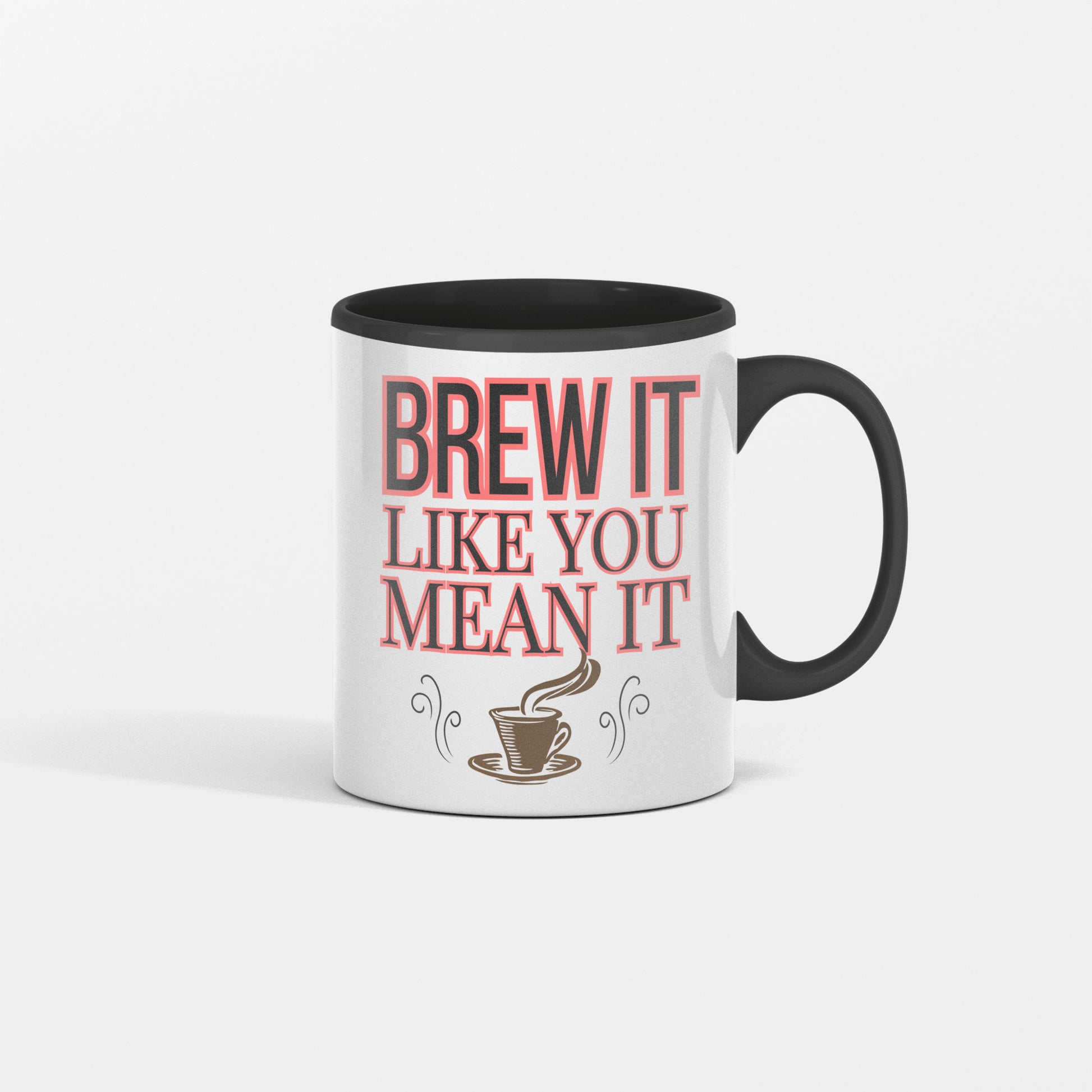 White ceramic coffee mug with bold black text reading "Brew It Like You Mean It" sitting on a wooden desk with steam rising from the cup.