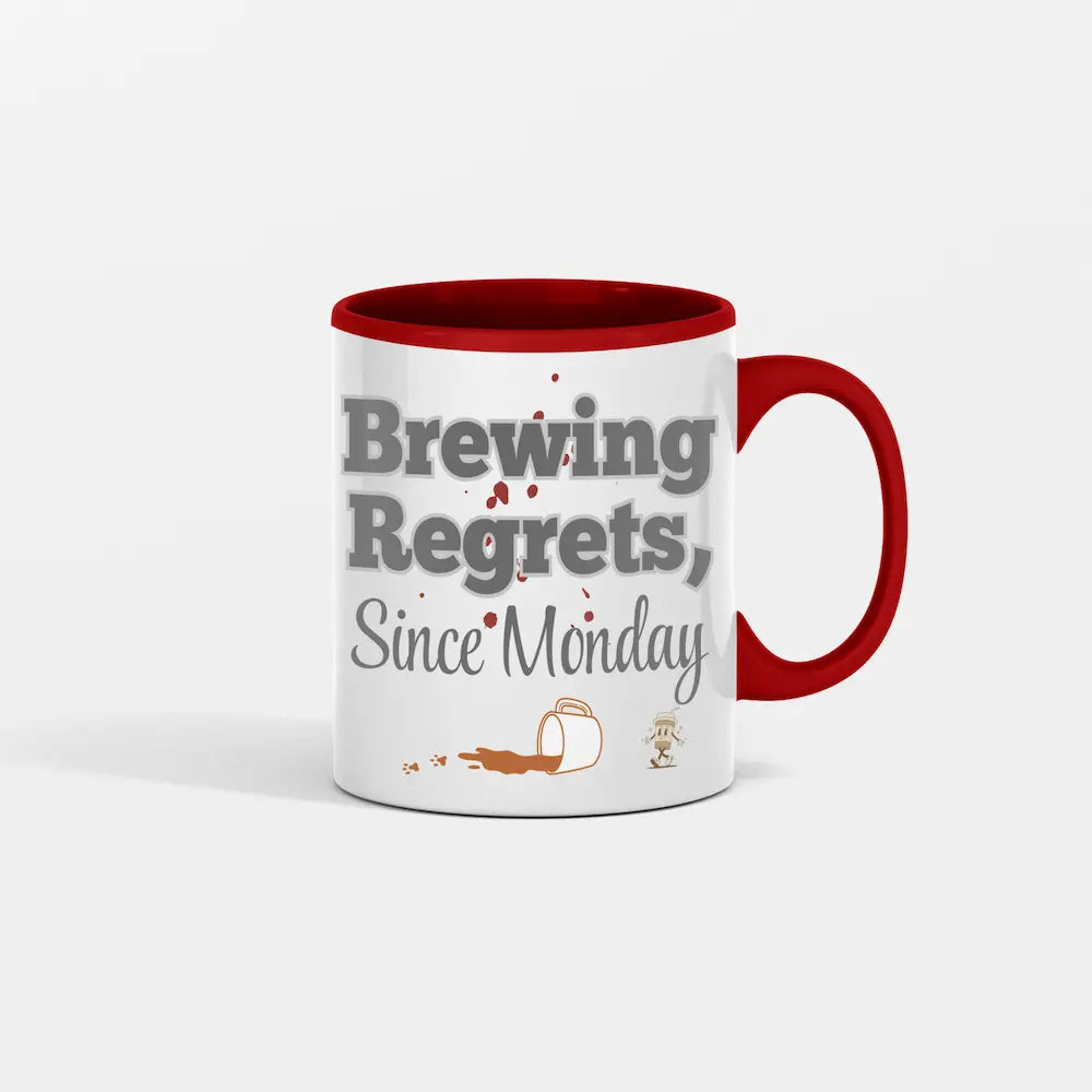 White ceramic mug with bold black text: “Brew Regrets Since Monday” and spilled coffee stain detail on background.