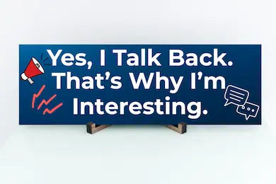 Funny humorous wall plaque with the phrase “YES, I TALK BACK – THAT’S WHY I’M INTERESTING” in bold lettering.