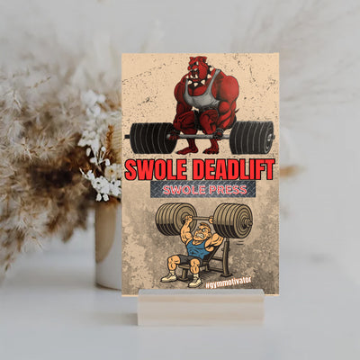 SWOLE Deadlift/Press motivational gym plaque hanging on gym wall near weights.