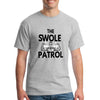 Athlete lifting weights wearing The Swole Patrol black performance T-shirt in industrial gym.