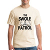 Athlete lifting weights wearing The Swole Patrol black performance T-shirt in industrial gym.