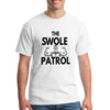 Athlete lifting weights wearing The Swole Patrol black performance T-shirt in industrial gym.