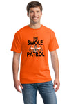 Athlete lifting weights wearing The Swole Patrol black performance T-shirt in industrial gym.