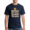 Grandma and grandpa wearing "Retired But Still Running the Show" funny retirement T-shirt, smiling with confidence.