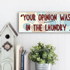 Sarcastic wall plaque with the phrase “Your Opinion Wasn’t in the Laundry” – bold home office décor gift
