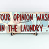 Sarcastic wall plaque with the phrase “Your Opinion Wasn’t in the Laundry” – bold home office décor gift