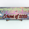 Plaque design reading Heartbeat of the Game, Echoes of 2026 with heartbeat line shaping into a World Cup ball, radiating soundwaves.