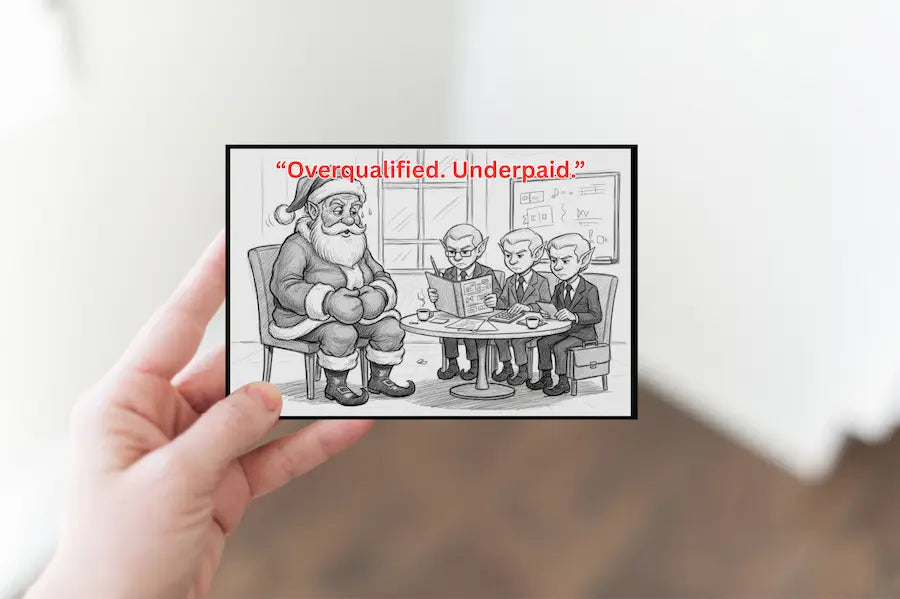 Hand-drawn Christmas postcard featuring Santa slumped at a desk with a broken pen, bills scattered, and the bold text “Overqualified. Underpaid.” in vintage holiday typography.