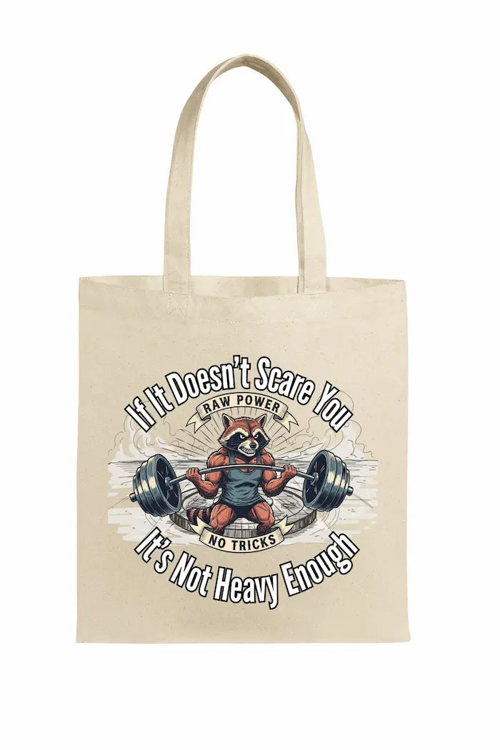 Canvas tote bag printed with “If It Doesn’t Scare You, It’s Not Heavy Enough” in bold hand-drawn typography with chalk-style texture.