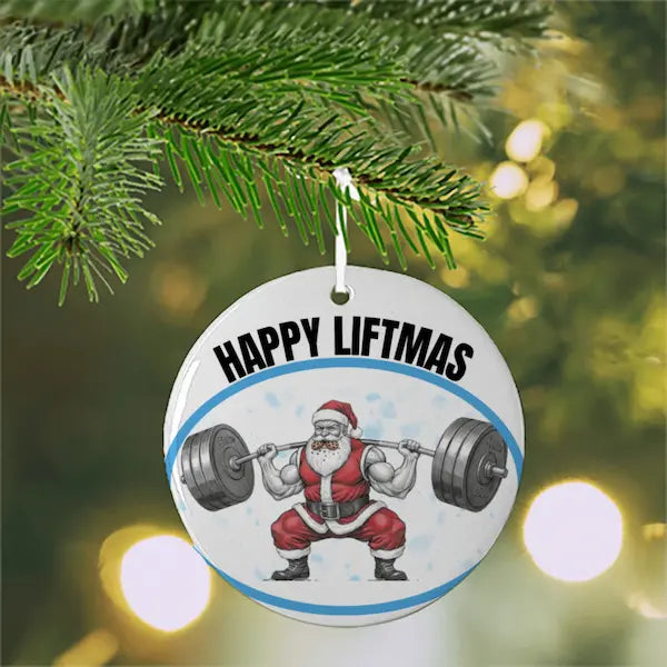 Christmas ornament with Santa Claus lifting weights and 'Happy Liftmas' text, hanging on a tree.