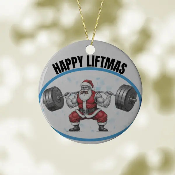 Ornament with Santa Claus lifting weights and 'Happy Liftmas' text on a blurred background