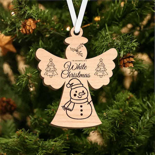 Wooden angel ornament with 'Dreaming of a White Christmas' text on a Christmas tree.