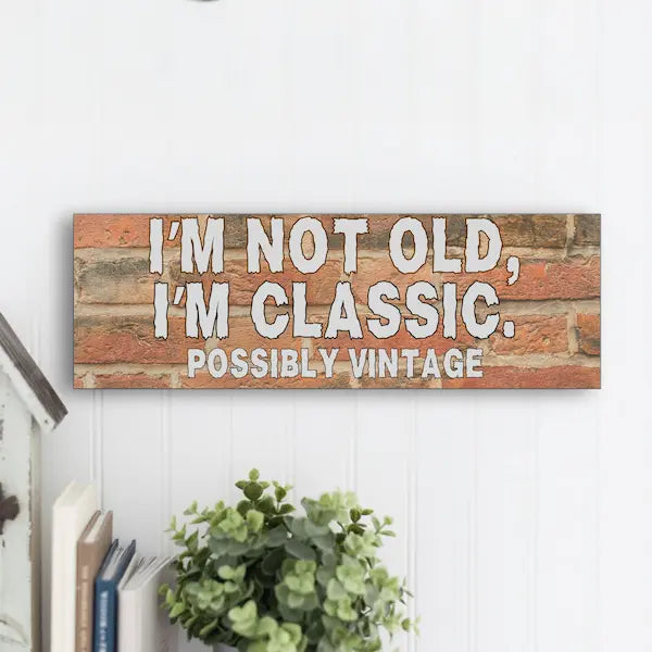 “Funny sarcastic plaque reading ‘I’m Not Old, I’m Classic Possibly Vintage’ printed on MDF retro-style wall sign”