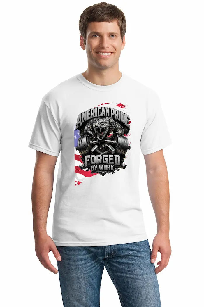 Cotton T-shirt with bold “American Pride – Forged by Work” text, modeled on a rugged workspace background.