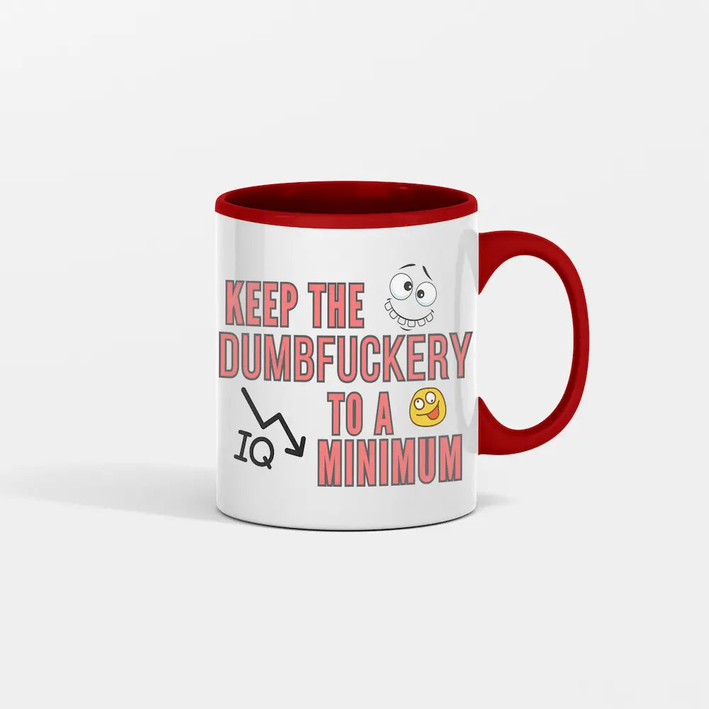 Ceramic coffee mug reading “Keep The Dumbfuckery to a Minimum” on a work desk with coffee steam rising