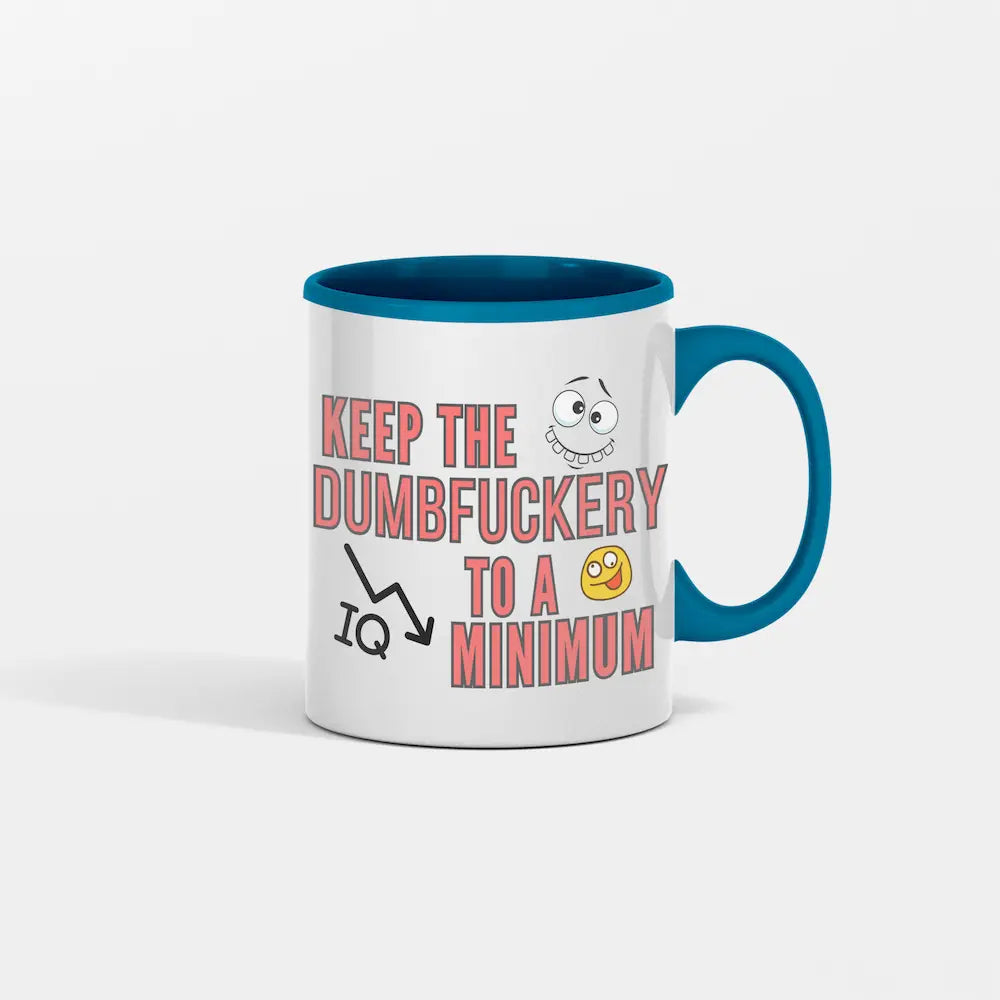 Ceramic coffee mug reading “Keep The Dumbfuckery to a Minimum” on a work desk with coffee steam rising